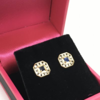 A pair of 9 carat earrings set with a central sapphire surrounded by diamond stones. 1.7g total weight Postage category A