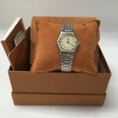 A ladies gold and steel Ebel watch, with box and papers.