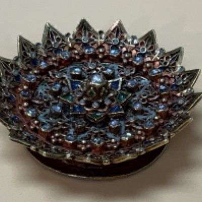 A very unusual Hellenistic (Olbia) style high carat gold trinket (worn by vendor on lace) inset with Chrysobel, granular enamel and filigree floral decoration. Weight 29.35g, 49mm Diameter x 18.5mm.