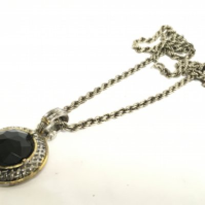 A silver chain with a black stone pendant. Postage cat A NO RESERVE