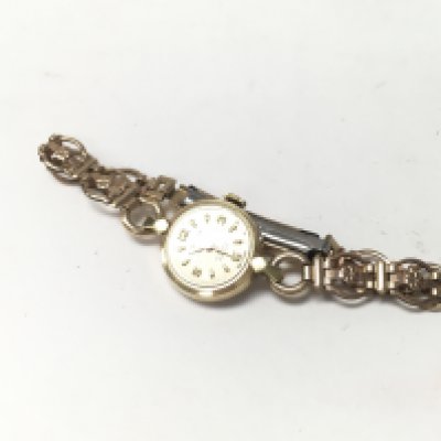 A 14ct cased gold ladies watch with a rolled gold strap.