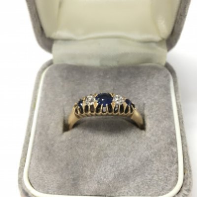 An 18ct gold ring set with sapphires and diamonds. Approx weight 3.2grams, ring size L.