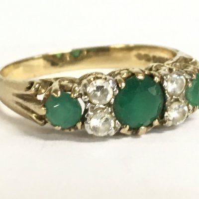 A 9 carat gold green and Cubic Zirconia ring , P/Q. 2.1g Postage category A