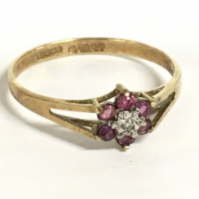 A 9 carat ruby and diamond set flower ring size Q, 1.25g. Postage category A
