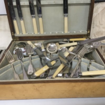 A canteen containing mixed cutlery a cased set of fruit knifes and a cased set of fish knifes with mother of pearl handles.