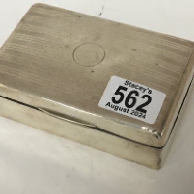 A silver desk top cigarette box. of rectangular shape.