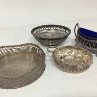 A Dutch Silver wine coaster a silver wine taster a salt cellar and a small dish.