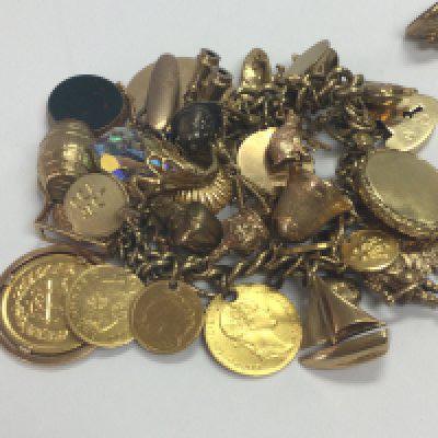 A 9 ct god bracelet with numerous charms attached total weight 123 grams