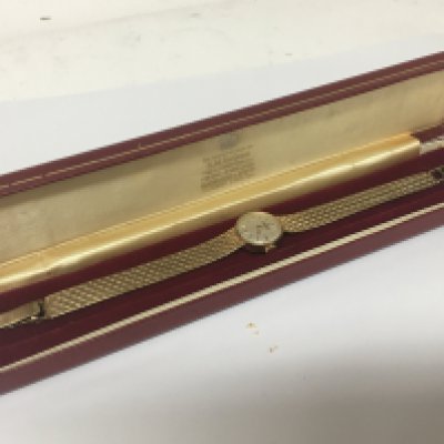 A ladies 9carat gold Garrard watch manual wind in a fitted box. Reserve with personal inscription Total weight 21g. Seen working.