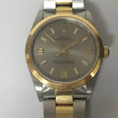 A Gents Rolex stainless steel and gold Oyster Perpetual Superlative Chronometer the silver chrome dial with raised batten and numerals the watch lightly worn and seen working model number 160 serial number Y544776 box and paperwork Rolex swing tag extra links leather Rolex wallet and outer box.