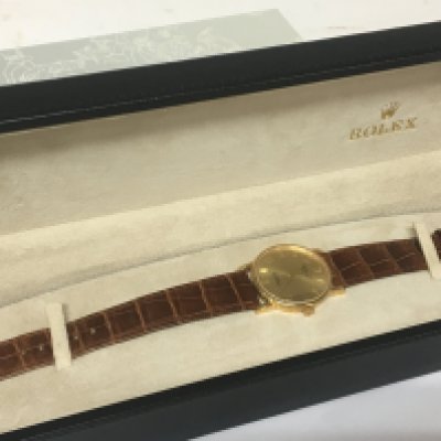A Rolex watch 18carat gold cased Cellini with Rolex leather strap very lightly worn seen working a few minor scratches in Rolex box with paperwork serial number K688573 model 5115 with leather wallet Rolex Cellini mini brochure and outer box.