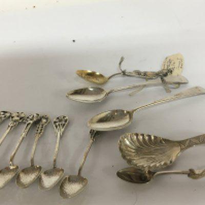 A set of six Art Nouveau silver coffee spoons a tea caddy spoon and other George III silver tea spoons.