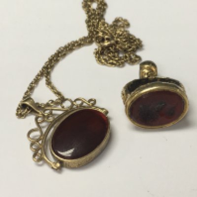 A 9 ct gold chain with attached swivel fob and one other fob .