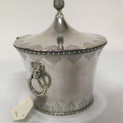A Quality Silver biscuit box with a hinged round lid with acorn finial and raised lion mask and ring side handles gilded interior and patterned edge. Height 18cm weight 520g