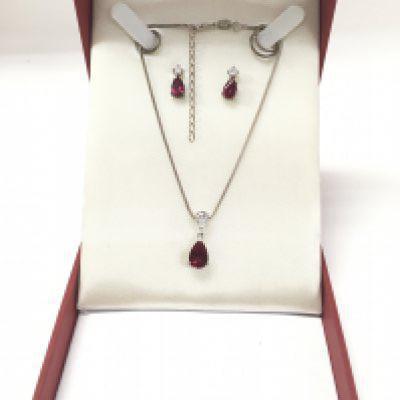A sterling silver necklace set with simulated rubys and cz with a matching pair of earrings.