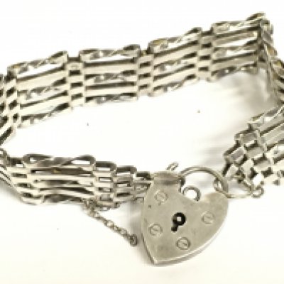 A silver hallmarked gate bracelet. Postage category a