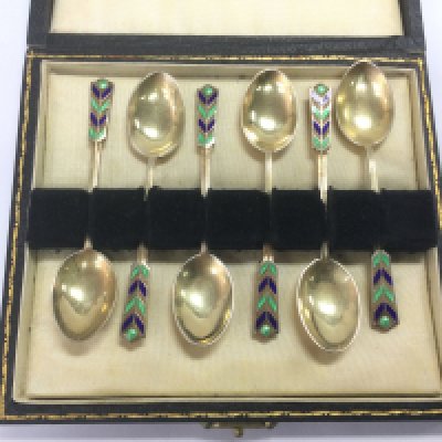 A cased set of six silver and enamelled tea spoons. Shipping category B.