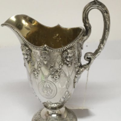 A Quality Victorian silver and parcel gilt cream jug decorated with raised masks and garlands London 1861 hallmarks height 17cm 272g