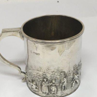 A silver christening mug decorated with raised figures Chester hallmarks for 1902 weight 114g Hight 7.5cm