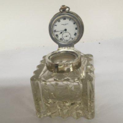 A silver and cut glass novelty ink well the hinged silver cap inset with a button wind pocket watch maker James Walker London. no obvious damage.