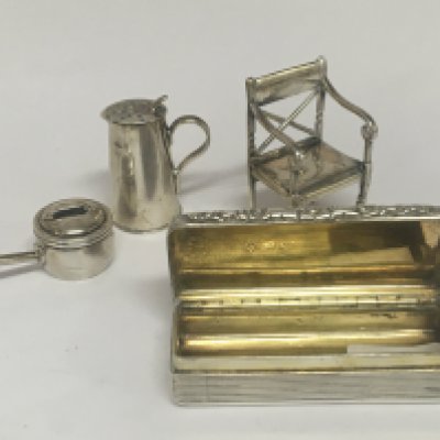 A silver snuff box Birmingham hallmarks early 19th century a miniature silver chair Birmingham 1913 hallmarks a miniature cooking pot and silver jug (4)