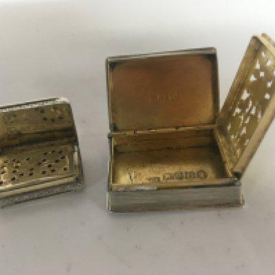Two Victorian silver and parcel gilt Vinaigrettes one in the form of a book late George III London hallmarks the smaller with Victorian marks (2)
