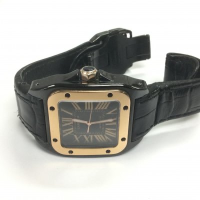 A Cartier 2878 33mm watch in black with a rose gold bezel. Shipping category B.