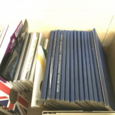 A box containing British blue coin collection albums including Pennies, Farthings and also a collection of Royal Mint commemorative coins. Postage category B