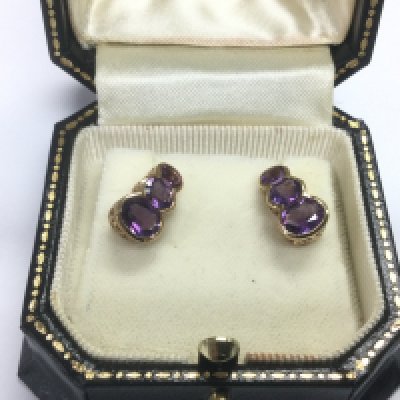 A pair of graduated 9ct gold and amethyst earrings, approx 2.6g. Shipping category A.