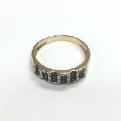A 9ct gold ring set with black and white diamonds, approx 2.5g and approx size O-P. Shipping category A.