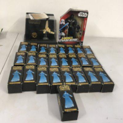 A collection of Star Wars models featuring 25 boxed numbered special edition Ghost of Obi Wan Kenobi.  Also includes display golden Imperial Shuttle and boxed Darth Vader.  No reserve