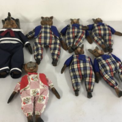 A collection of 7 toy animal figures  with carved wooden heads..hands and feet with stuffed bodies all dressed.  No reserve 