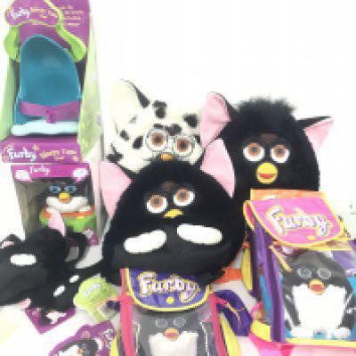 A Collection Of Furby Accessories Including Alarm Clock. Carry Along Bags. Sleepy Time Bed. Backpacks etc.