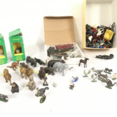 A collection of metal jungle an farm animals by Britains etc also a box of mixed metal fencing.  Includes box containing plastic figures mostly Lego plus 2 tetley tea teafolk houses.  No reserve 