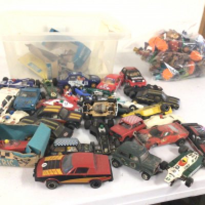 A box containing in excess of 25 Scalextric cars ideal for spares or repair.  Also bag containing Skylander figures.  No reserve