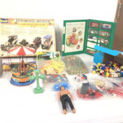An assorted collection of toys including Revell car kit..tin plate fairground ride..Thunderbirds figures and Asterix..Lego sets.figures etc.  no reserve