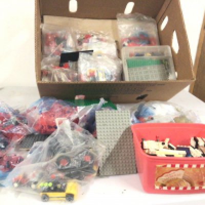 A large collection of Lego pieces some in sealed bags others loose in boxes and open bags.  Some instructions.  No reserve.