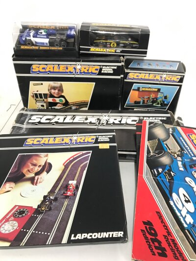 2 Boxed Scalextric Cars. A Ford Escort Mexico #C.052. A March Ford 240. A Auto Start. Pitstop. Lap counter. Hump Bridge. And Catalogues. And Track.