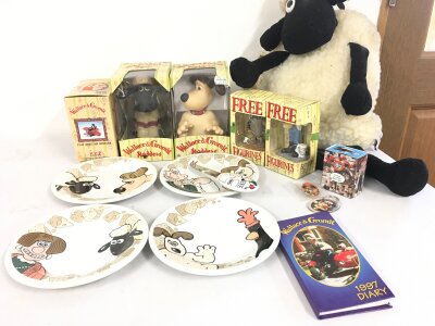A varied collection of Wallace and Gromit merchandise including Display figures, cheese plates, plush Shaun the Sheep.  No reserve