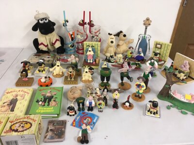 A large varied collection of Wallace and Gromit merchandise including display figures, personal organisers, bottle cork remover plus other items.  No reserve