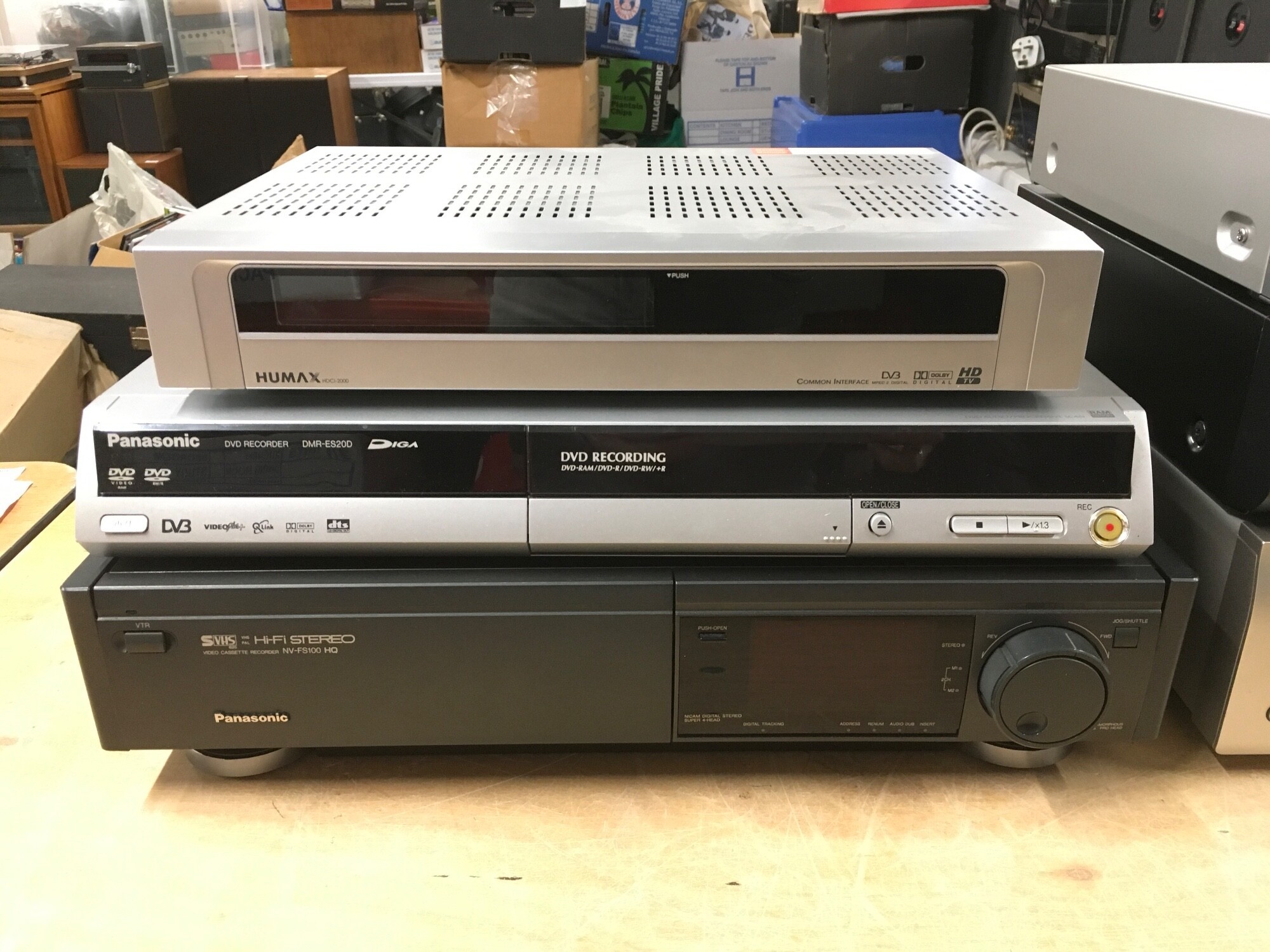 A boxed Panasonic DMR ES20D DVD recorder with remote control and power lead, a Panasonic NV-FS100 HQ video recorder with remote control, digital scanner and user guide plus a boxed Humax HD box with remote control (3).