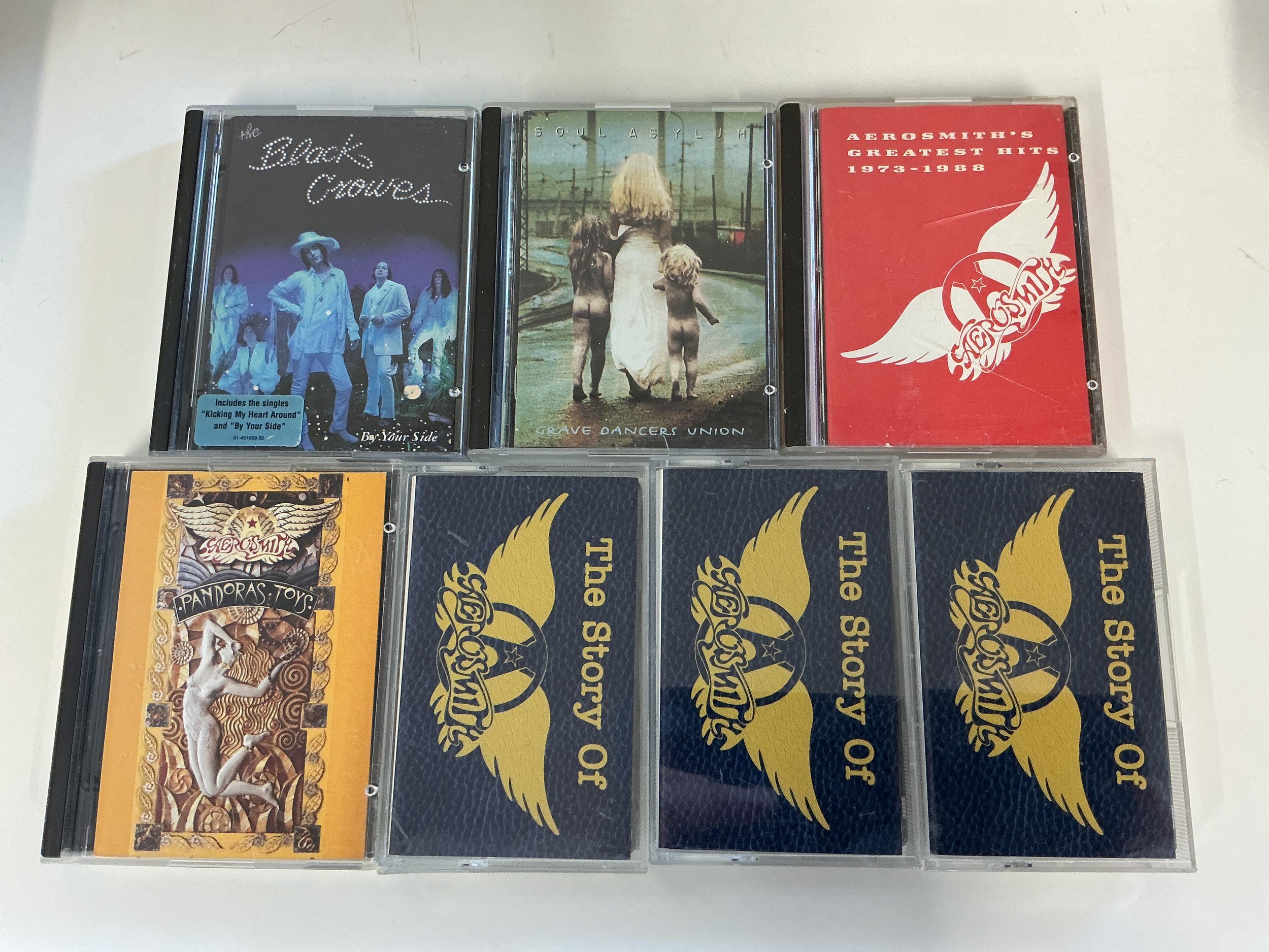 Four minidiscs by various artists including Aerosmith, Black Crowes and Soul Asylum plus three Aerosmith audio cassettes.
