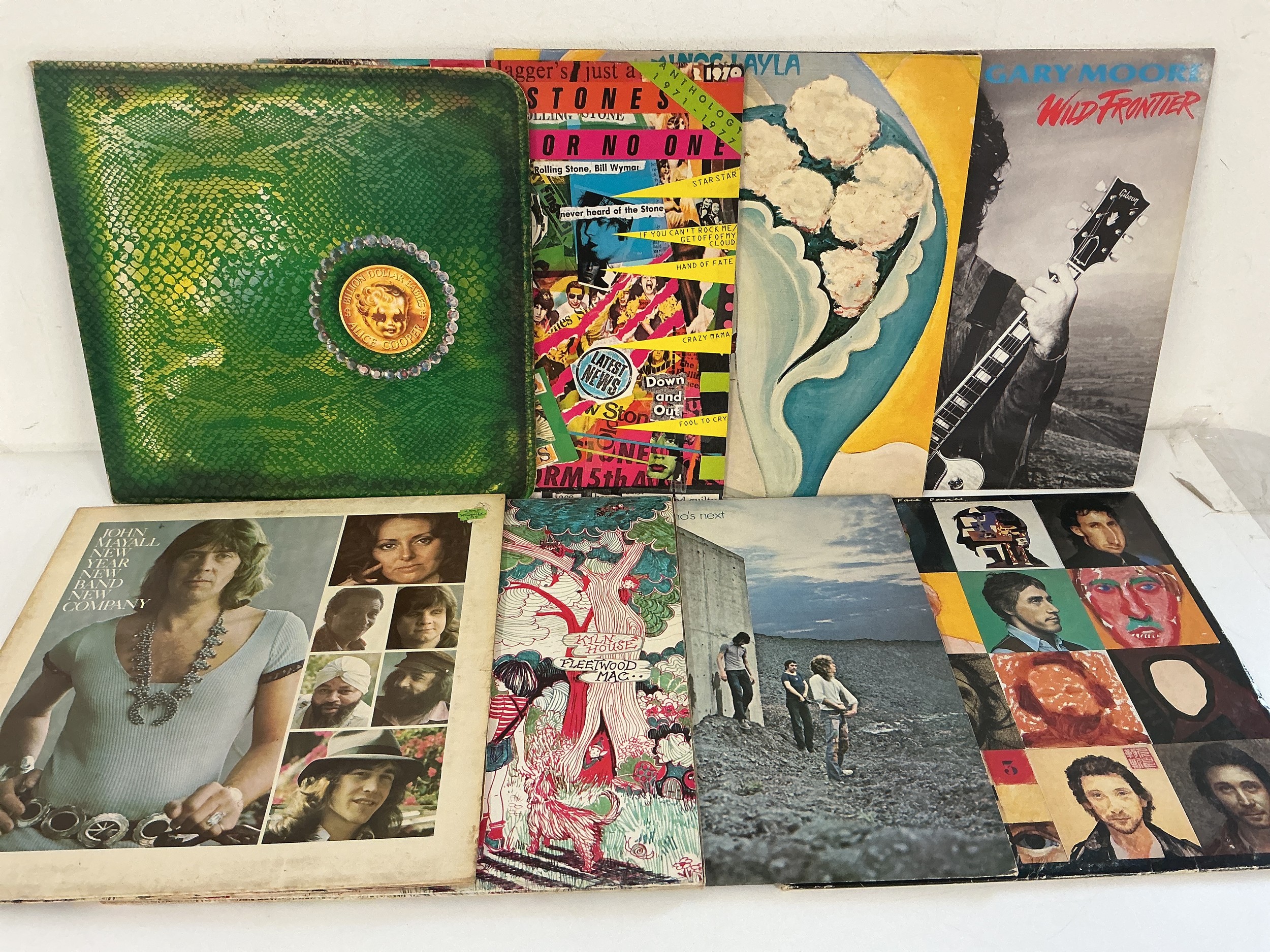 Two bags containing 16 rock LPs by various artists including Rush, The Rolling Stones, Alice Cooper, The Who and others.