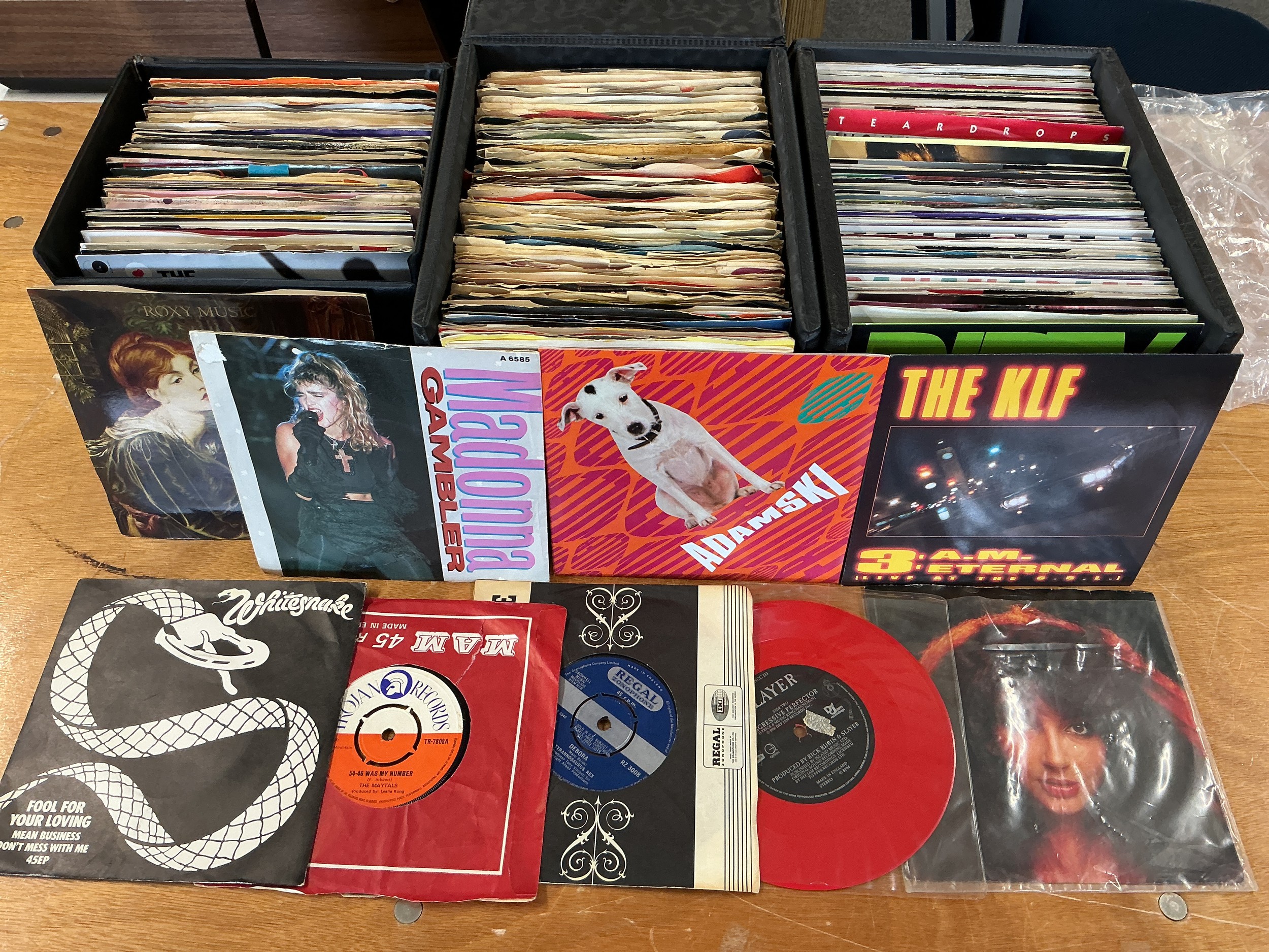 A collection of 7" singles and LPs in three record cases and a box by various artists including Tyrannosaurus Rex, Kate Bush, various Motown artists and many more.