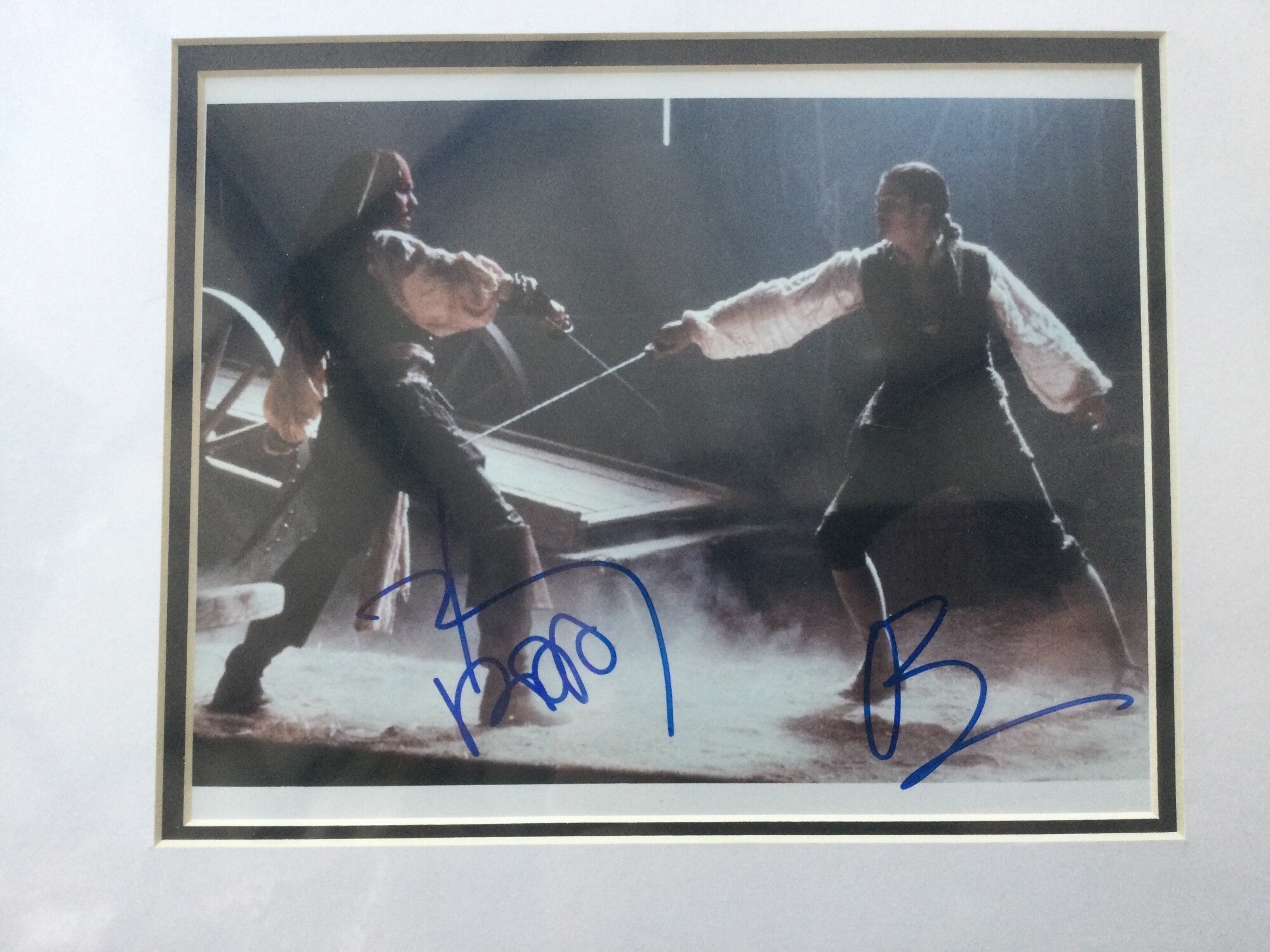 A Johnny Depp and Orlando Bloom signed photo from Pirates Of The Carribean, approx 39cm x 33cm including mount.