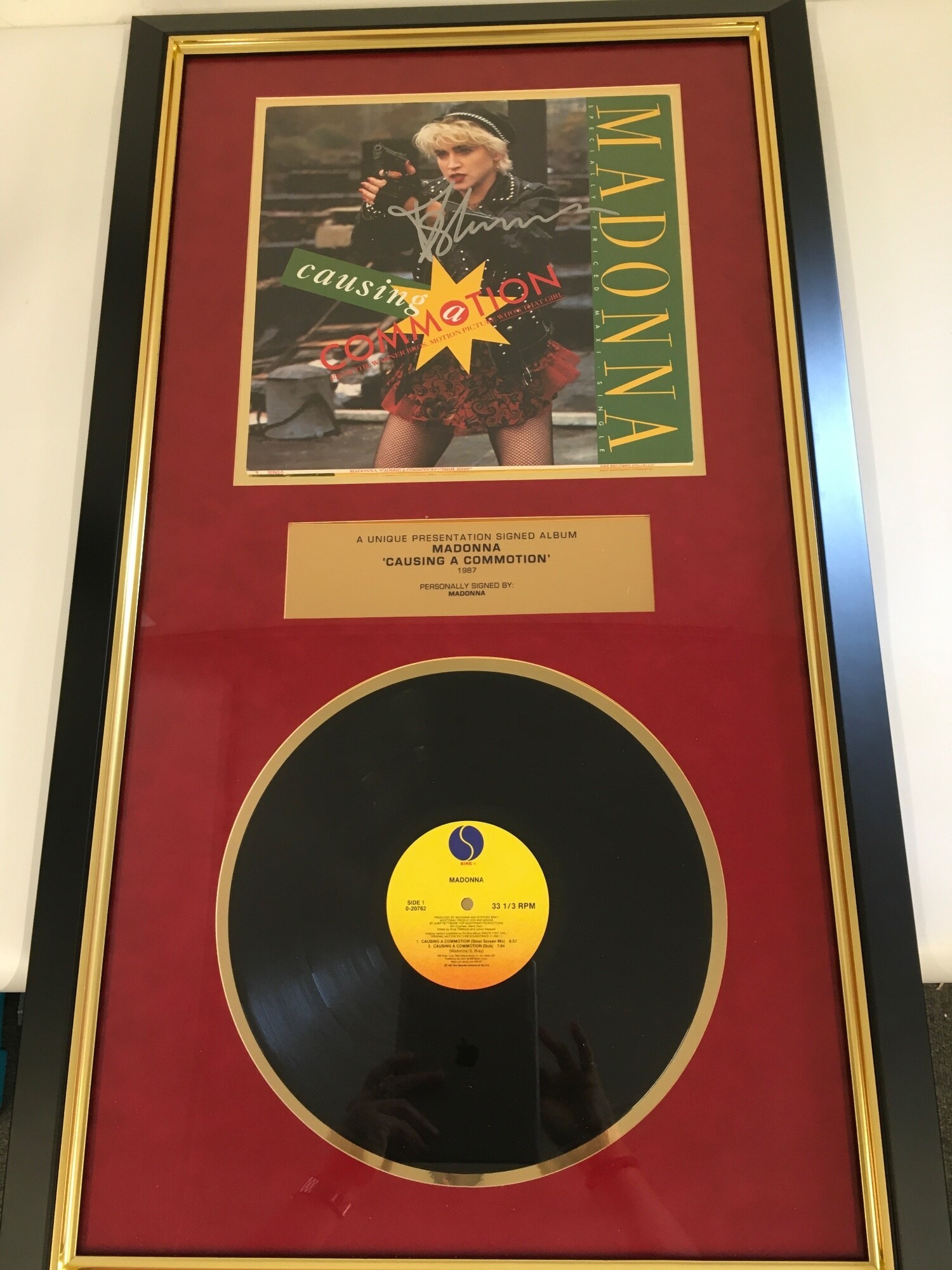 A framed and signed Madonna presentation display for the Causing A Commotion 12" single, Our Price PLC COA included. Approx 54cm x 95cm.