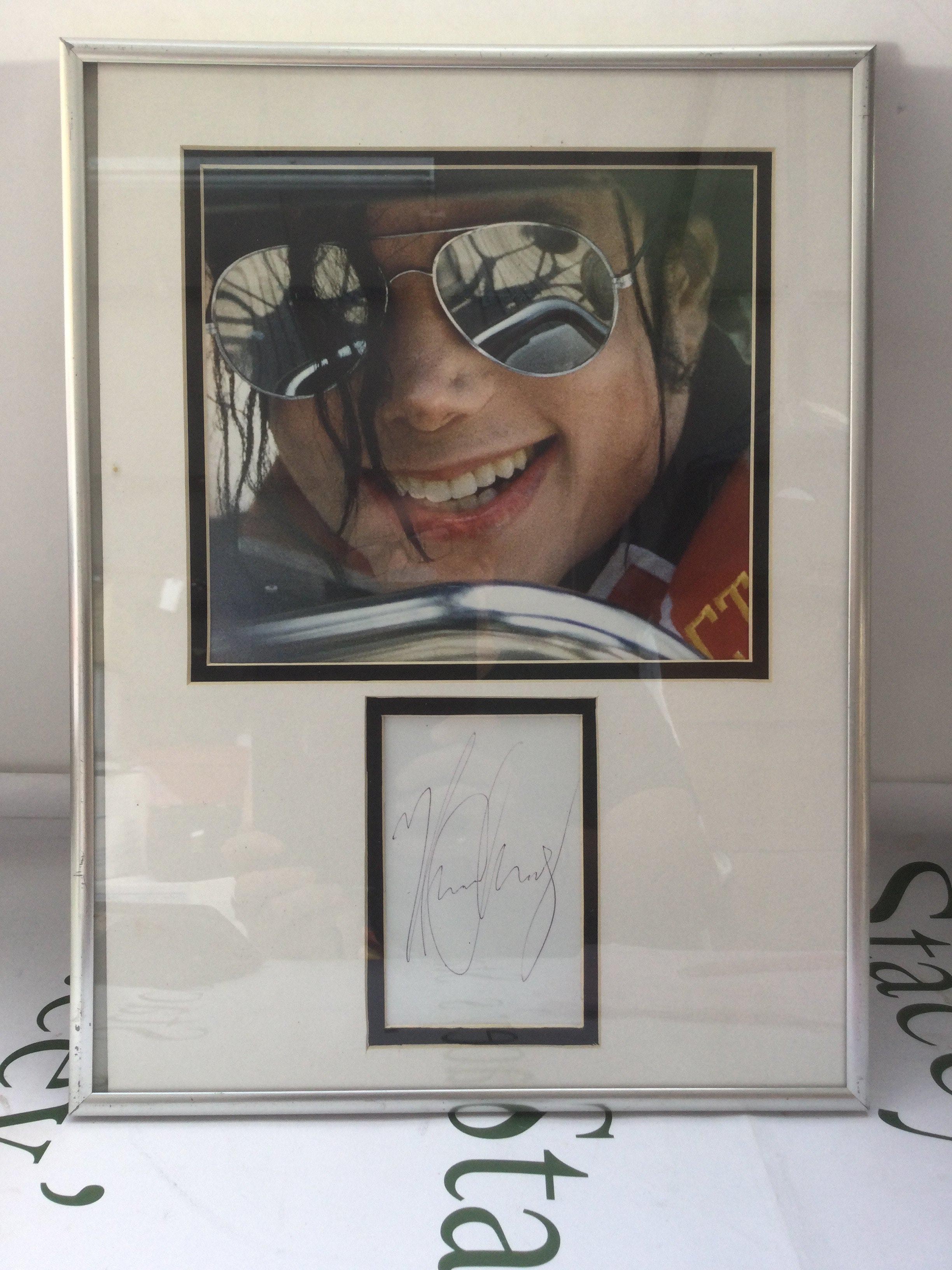 A framed and glazed signed Michael Jackson display, approx 31cm x 41cm. No COA.