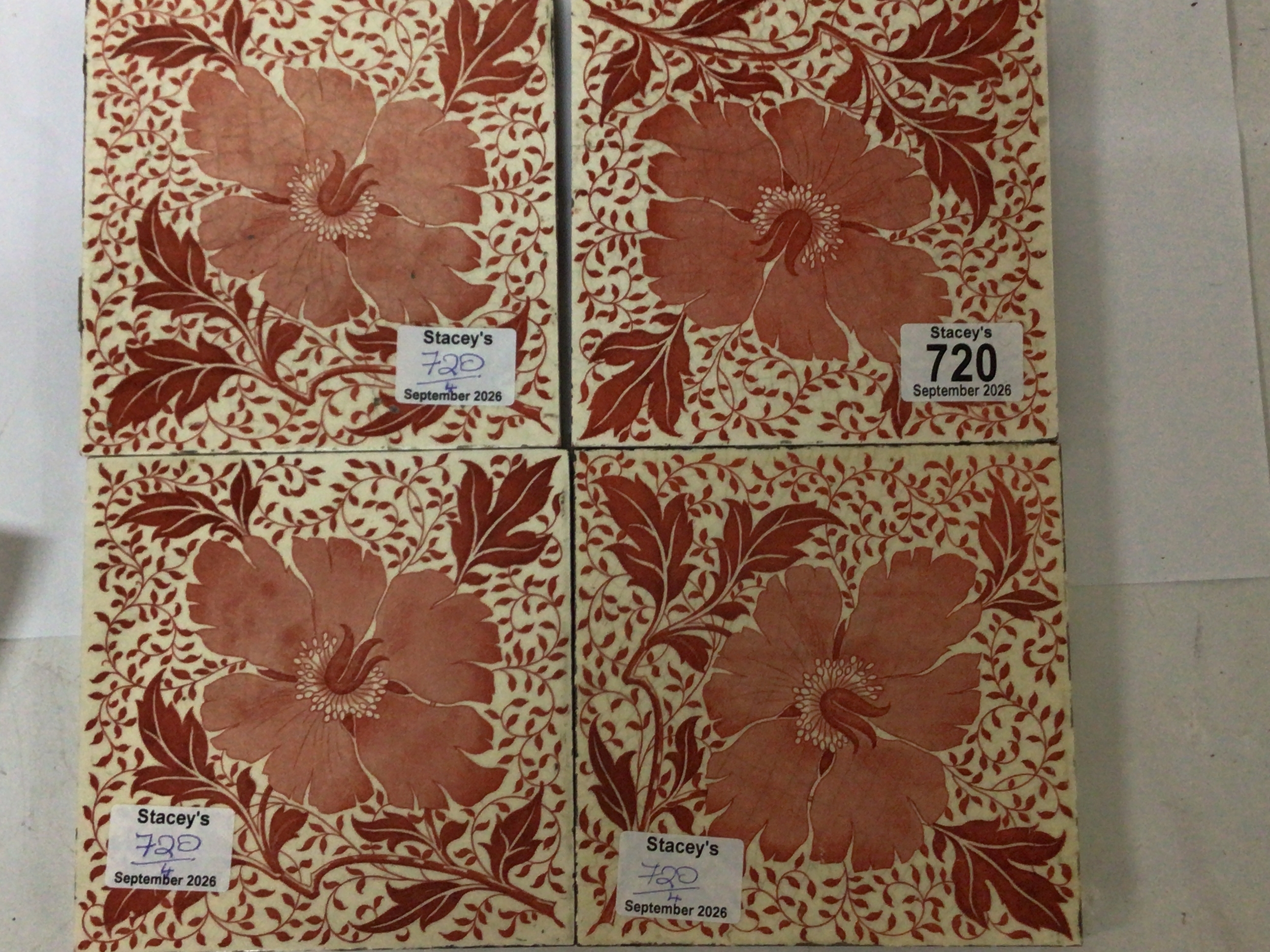  A set of four Minton Victorian tiles decorated in red with flowers and foliage of Arts and Crafts design and most likely by William De Morgan who often used Minton tiles, Apearing to be a unique design. The tiles with batch numbers to the reverse no obvious damage 15cm square. (4) 
