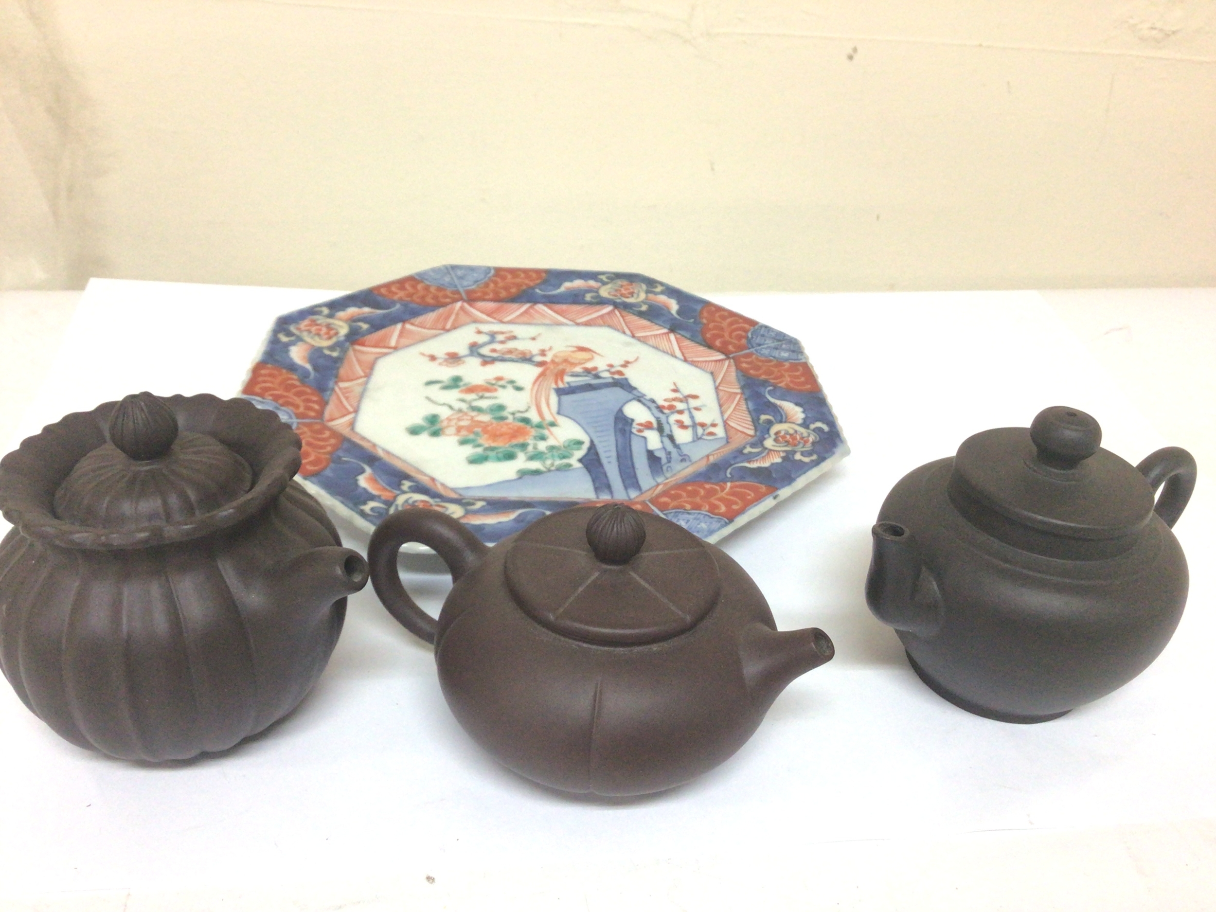  Three Chinese miniature terracotta dark brown teapots with caricature marks to the base and an Imari porcelain dish (4) 