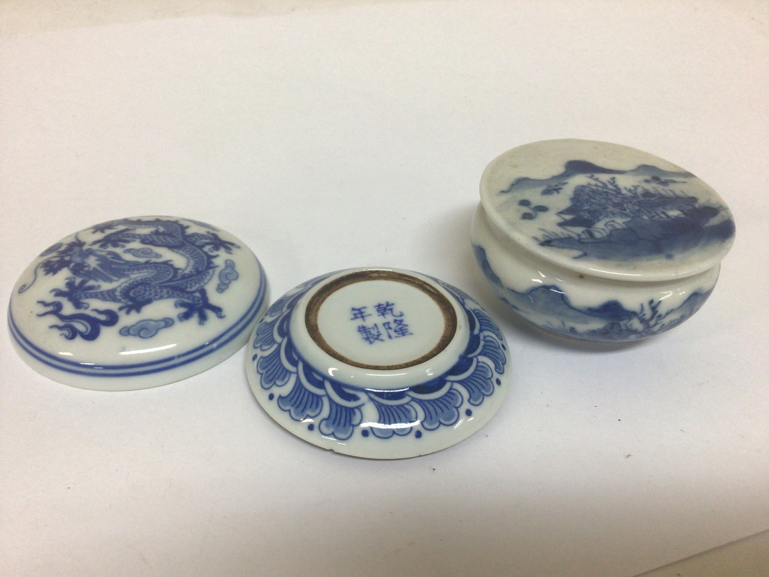 Two small Chinese export porcelain seal paste boxes 19th century of circular shape one with caricature marks to the base no obvious damage (2) 
